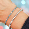 a close up of a bracelet with gemstones apatite